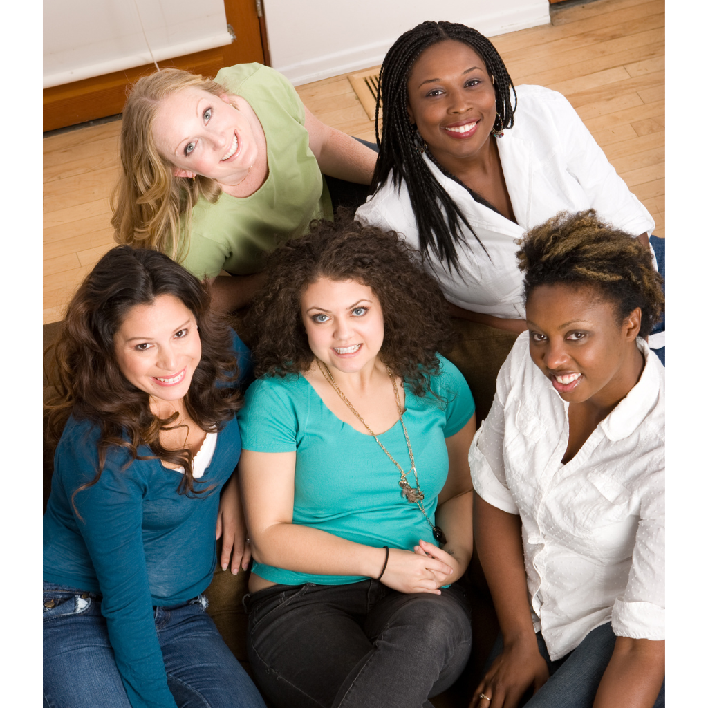 5 diverse women seated posing for picture